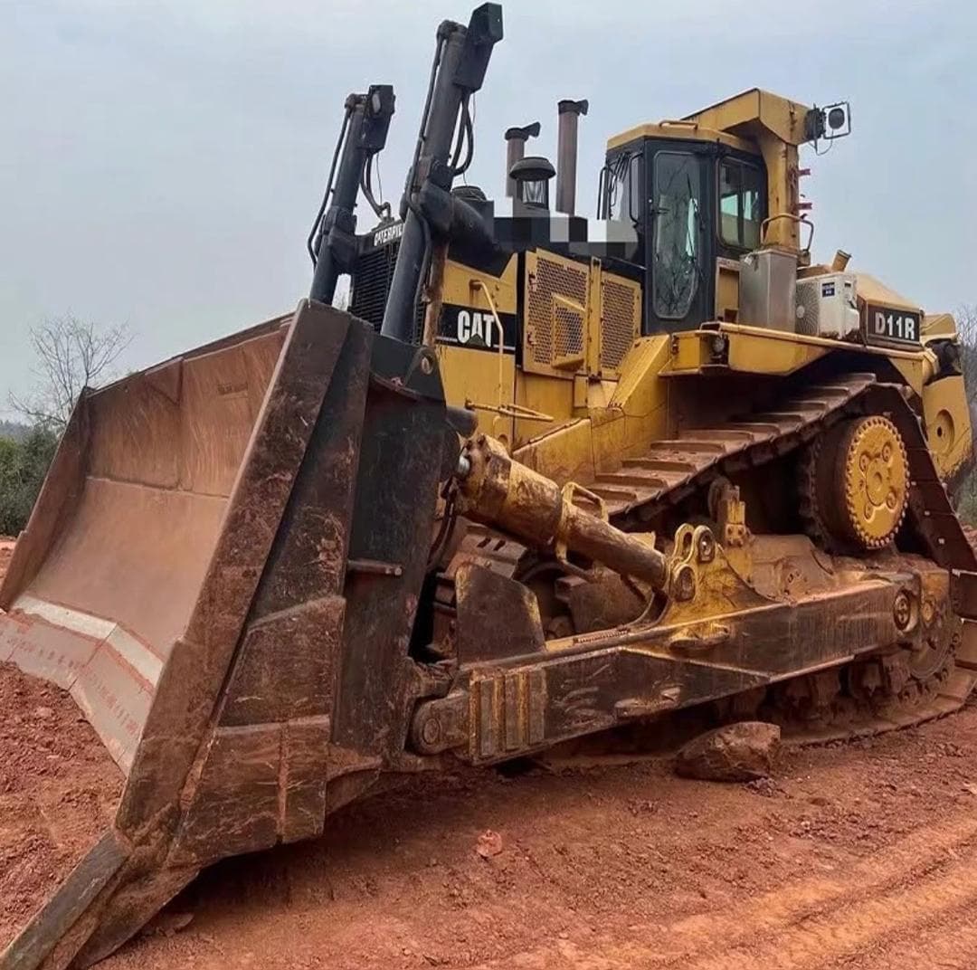Caterpillar D11R dozer with a wide U blade on red ground