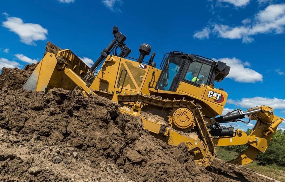 Caterpillar D8 dozer climbing a slope with the ripper lowered