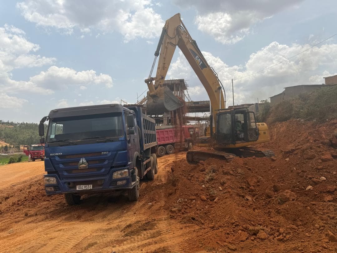 Blue HOWO 380 tipper being loaded by a Caterpillar excavator