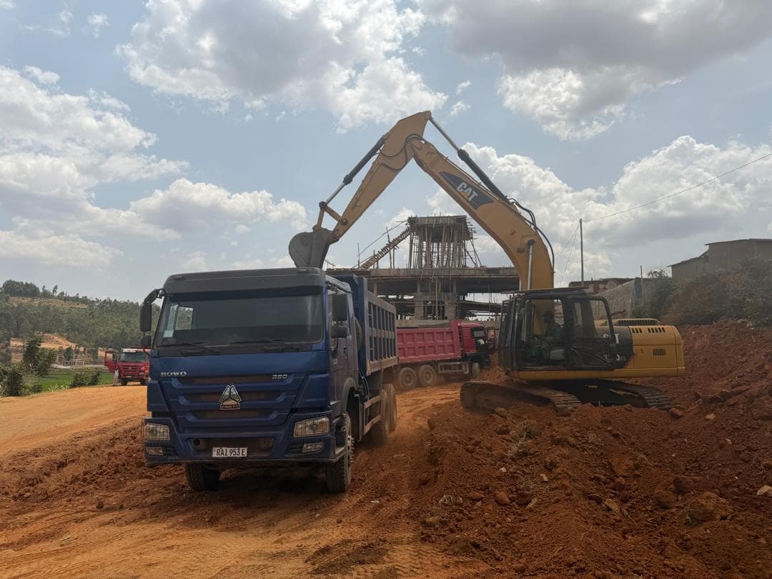 HOWO 380 tipper under an excavator at a bridge site